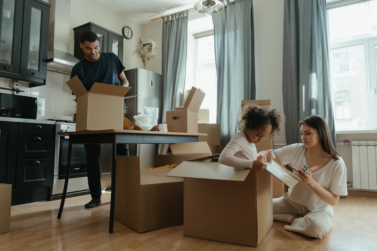 A family unpacks boxes in their new kitchen, enjoying the moving-in process.